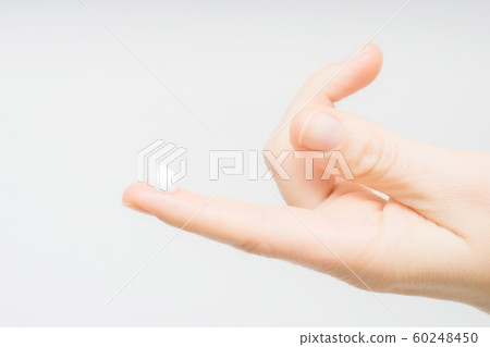 drop of moisturizing cream on fingertip. young girl or adult woman wearing hand cream. woman dropping collagen moisturizer serum into her finger. light background. soft picture 60248450
