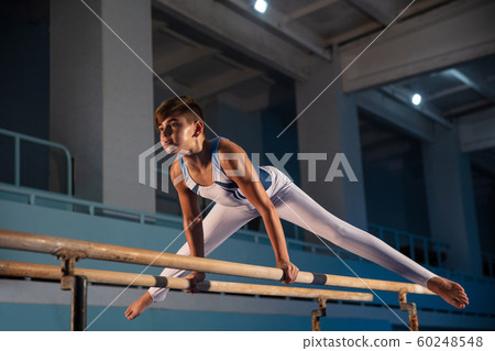Little male gymnast training in gym, flexible and active Little male gymnast training in gym, flexible and active 60248548