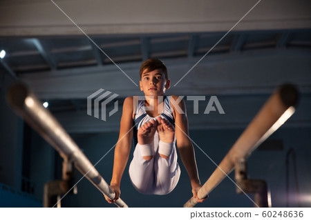 Little male gymnast training in gym, flexible and active 60248636