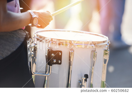 Drummers at a parade with white drumming - playing Drummers at a parade with white drumming - playing 60250682