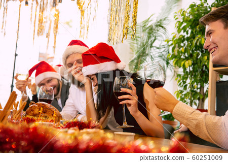 Happy co-workers celebrating while company party for New Year and Christmas 60251009