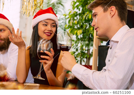 Happy co-workers celebrating while company party for New Year and Christmas 60251100