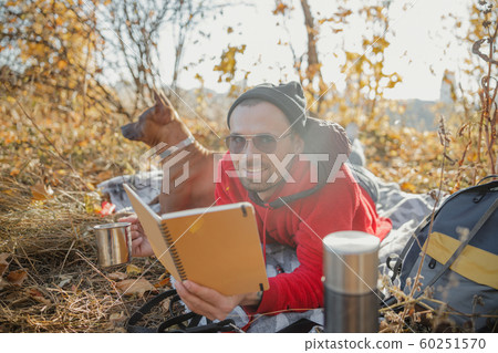 Tea and notebook at the picnic in forest stock photo Tea and notebook at the picnic in forest stock photo 60251570