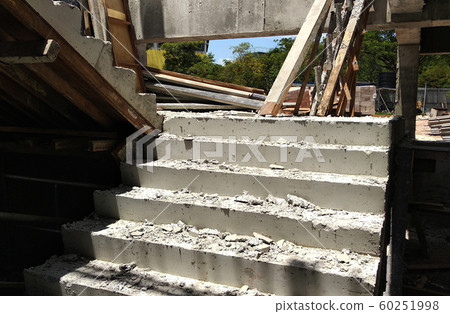 Concrete staircase under construction at the construction site. Timber formwork fabricated by construction workers as the staircase mold. 60251998