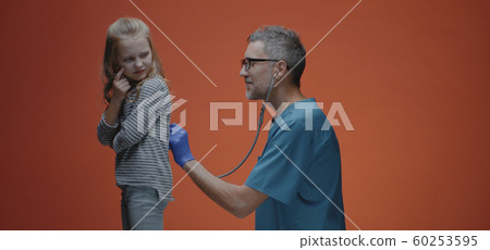 Doctor examining girl with stethoscope 60253595