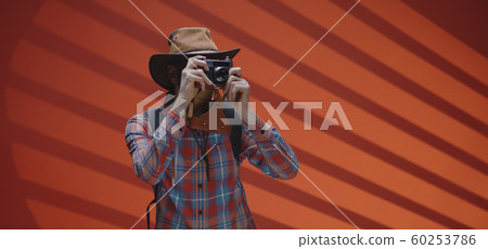 Middle-aged traveler walking and photographing 60253786