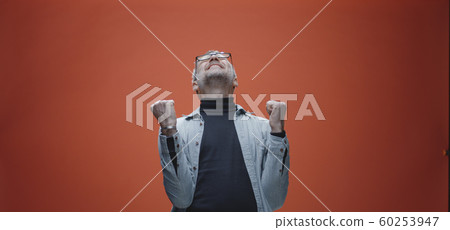 Delighted man celebrating success Delighted man celebrating success 60253947
