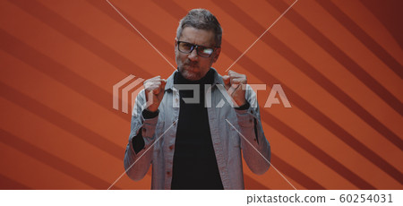 Angry man glaring at camera Angry man glaring at camera 60254031