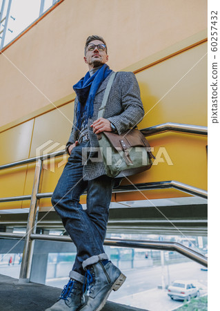 Elegant handsome man standing on the street Elegant handsome man standing on the street 60257432