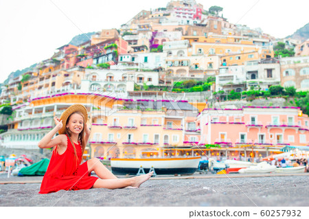 Adorable little girl on warm and sunny summer day in Positano town in Italy 60257932