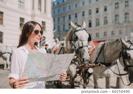 Woman walking in city. Young attractive tourist outdoors in italian city 60258490