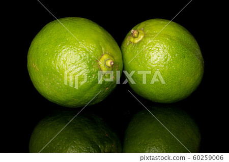 Green sour lime isolated on black glass 60259006