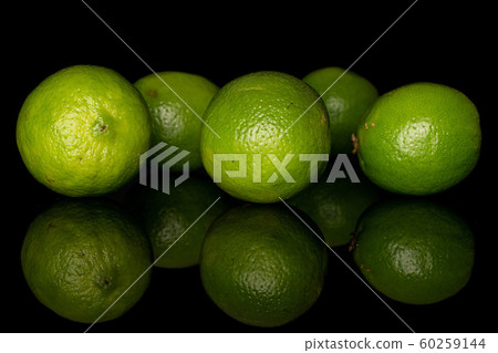 Green sour lime isolated on black glass Green sour lime isolated on black glass 60259144