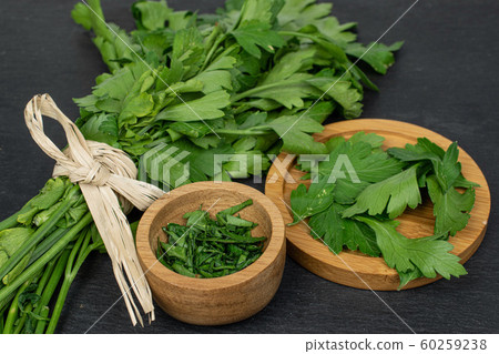 Flat leaf parsley on grey stone Flat leaf parsley on grey stone 60259238