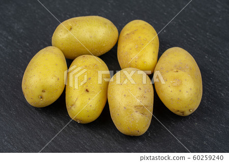 Yellow pale potato on grey stone Yellow pale potato on grey stone 60259240
