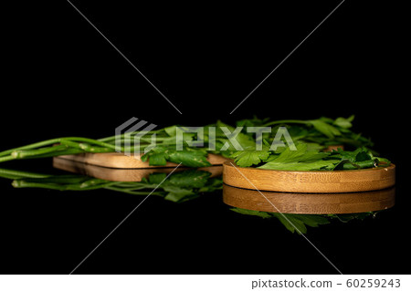 Flat leaf parsley isolated on black glass Flat leaf parsley isolated on black glass 60259243