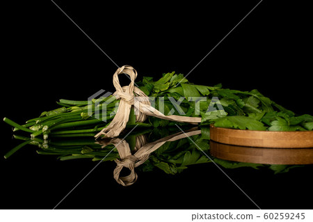 Flat leaf parsley isolated on black glass Flat leaf parsley isolated on black glass 60259245