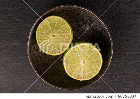 Green sour lime on grey stone Green sour lime on grey stone 60259334