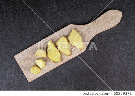 Fresh brown ginger on grey stone 60259371