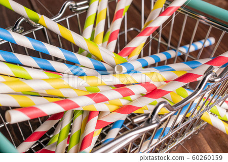Colorful paper straw on brown wood Colorful paper straw on brown wood 60260159