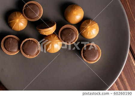Sweet brown toffee on brown wood 60260190
