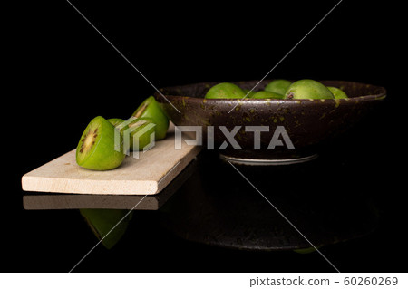 Hardy green kiwi isolated on black glass Hardy green kiwi isolated on black glass 60260269