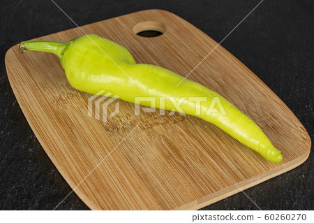 Hot green pepper on grey stone Hot green pepper on grey stone 60260270