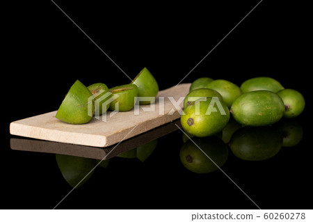 Hardy green kiwi isolated on black glass Hardy green kiwi isolated on black glass 60260278