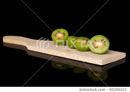Hardy green kiwi isolated on black glass 60260321