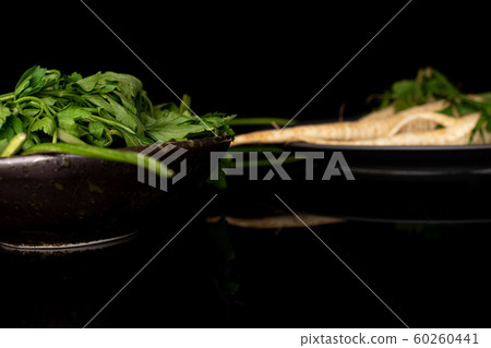 White parsley root isolated on black glass 60260441