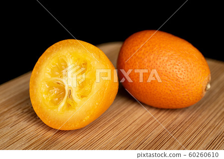 Tasty orange kumquat isolated on black glass 60260610