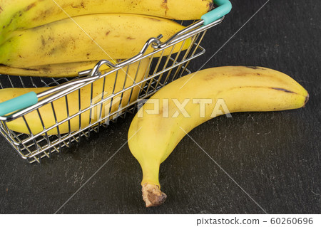 Sweet yellow banana on grey stone Sweet yellow banana on grey stone 60260696