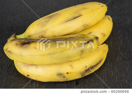 Sweet yellow banana on grey stone Sweet yellow banana on grey stone 60260698