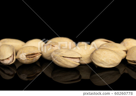Salted pistachio isolated on black glass Salted pistachio isolated on black glass 60260778