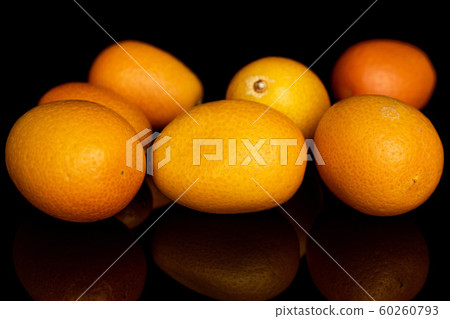 Tasty orange kumquat isolated on black glass Tasty orange kumquat isolated on black glass 60260793