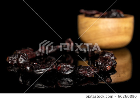 Dried cowberry isolated on black glass Dried cowberry isolated on black glass 60260880