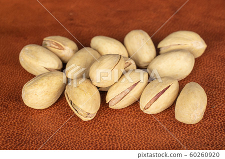 Salted pistachio on cognac leather 60260920