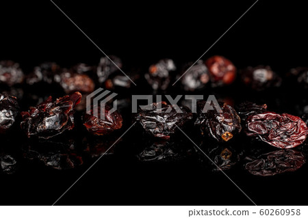 Dried cowberry isolated on black glass Dried cowberry isolated on black glass 60260958