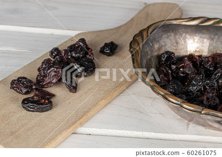 Dried cowberry on grey wood Dried cowberry on grey wood 60261075