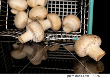 Fresh white mushroom isolated on black glass Fresh white mushroom isolated on black glass 60261109