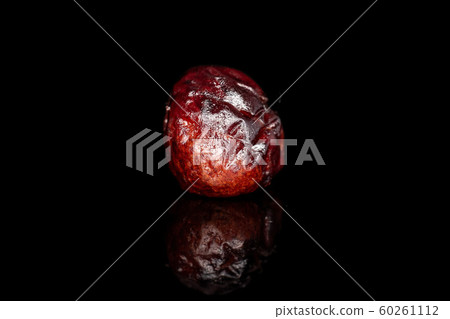 Dried cowberry isolated on black glass Dried cowberry isolated on black glass 60261112