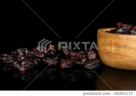 Dried cowberry isolated on black glass Dried cowberry isolated on black glass 60261117