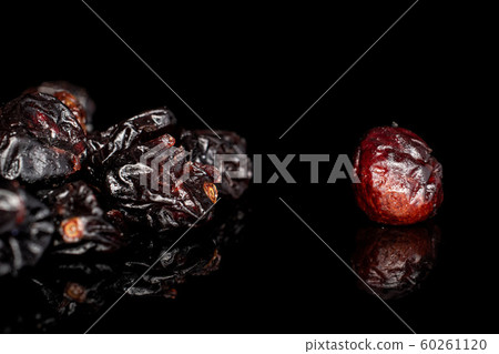 Dried cowberry isolated on black glass 60261120
