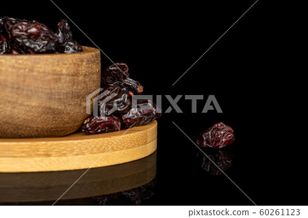 Dried cowberry isolated on black glass Dried cowberry isolated on black glass 60261123