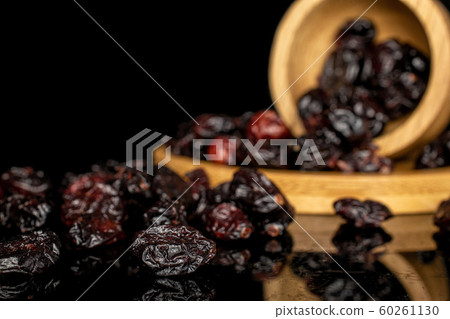 Dried cowberry isolated on black glass Dried cowberry isolated on black glass 60261130