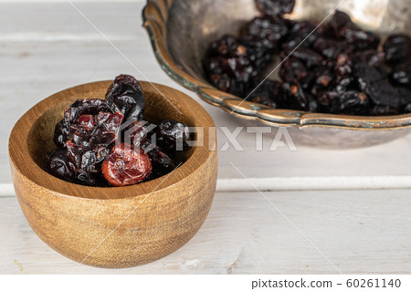 Dried cowberry on grey wood Dried cowberry on grey wood 60261140