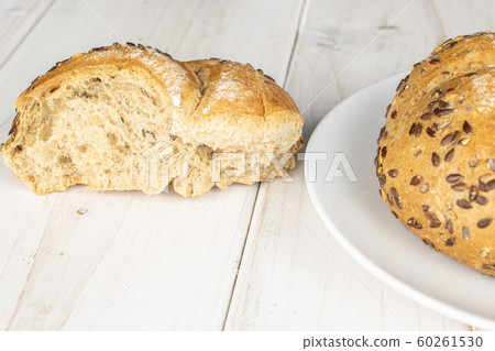 Sesame kaiser roll on grey wood Sesame kaiser roll on grey wood 60261530