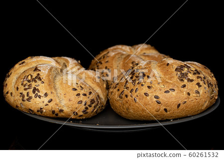 Sesame kaiser roll isolated on black glass Sesame kaiser roll isolated on black glass 60261532