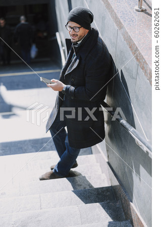 Caucasian attractive man leaning on the wall on stairs Caucasian attractive man leaning on the wall on stairs 60262061