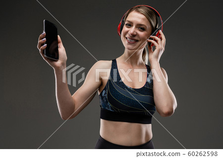 Sport woman listen to music with big earphones 60262598